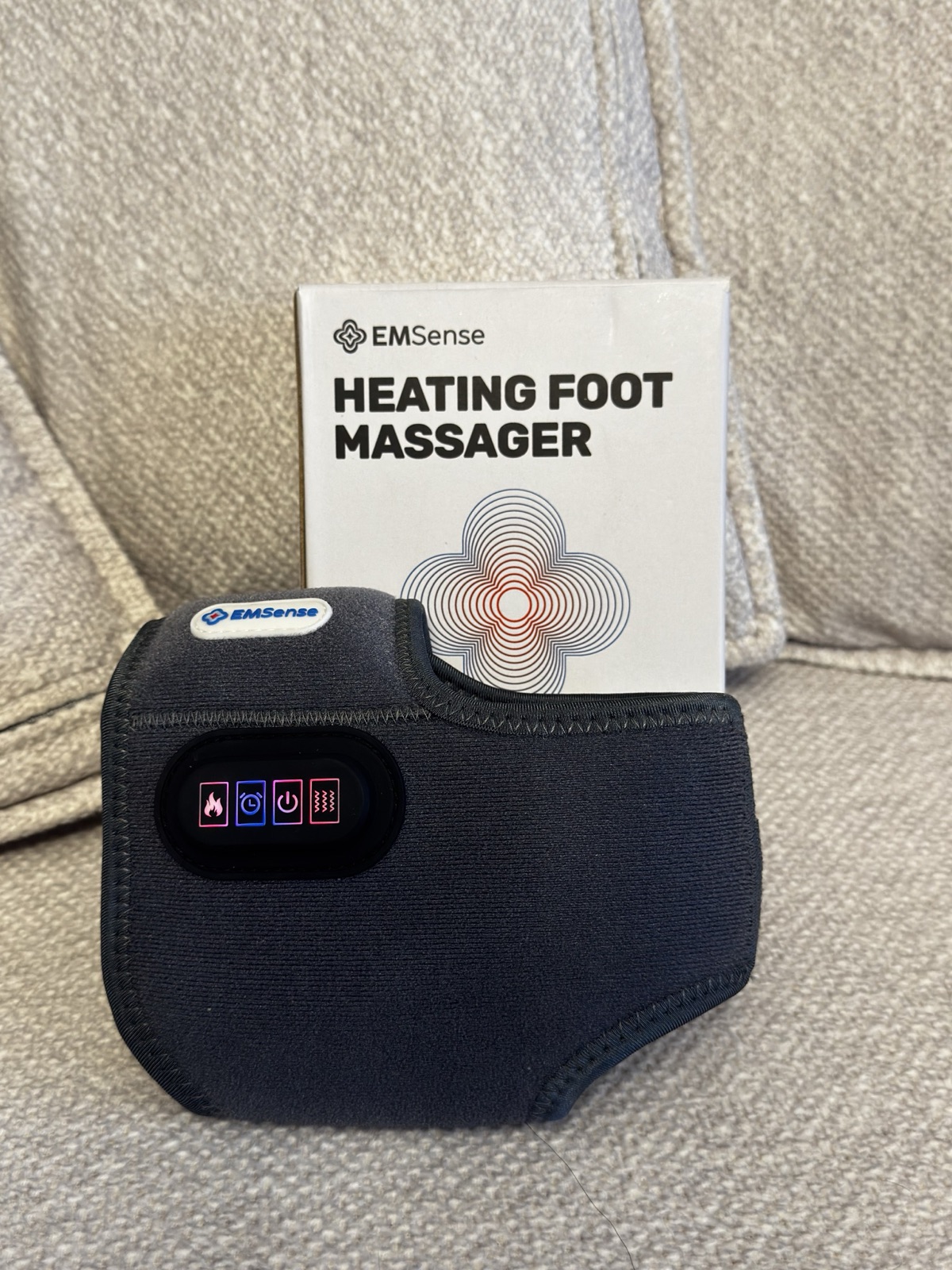 EMSense foot massager next to its box